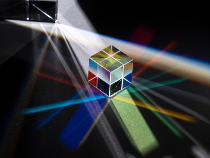 Prism refracting light into distinct paths, illustrating post-show technology review and careful evaluation of print opportunities.